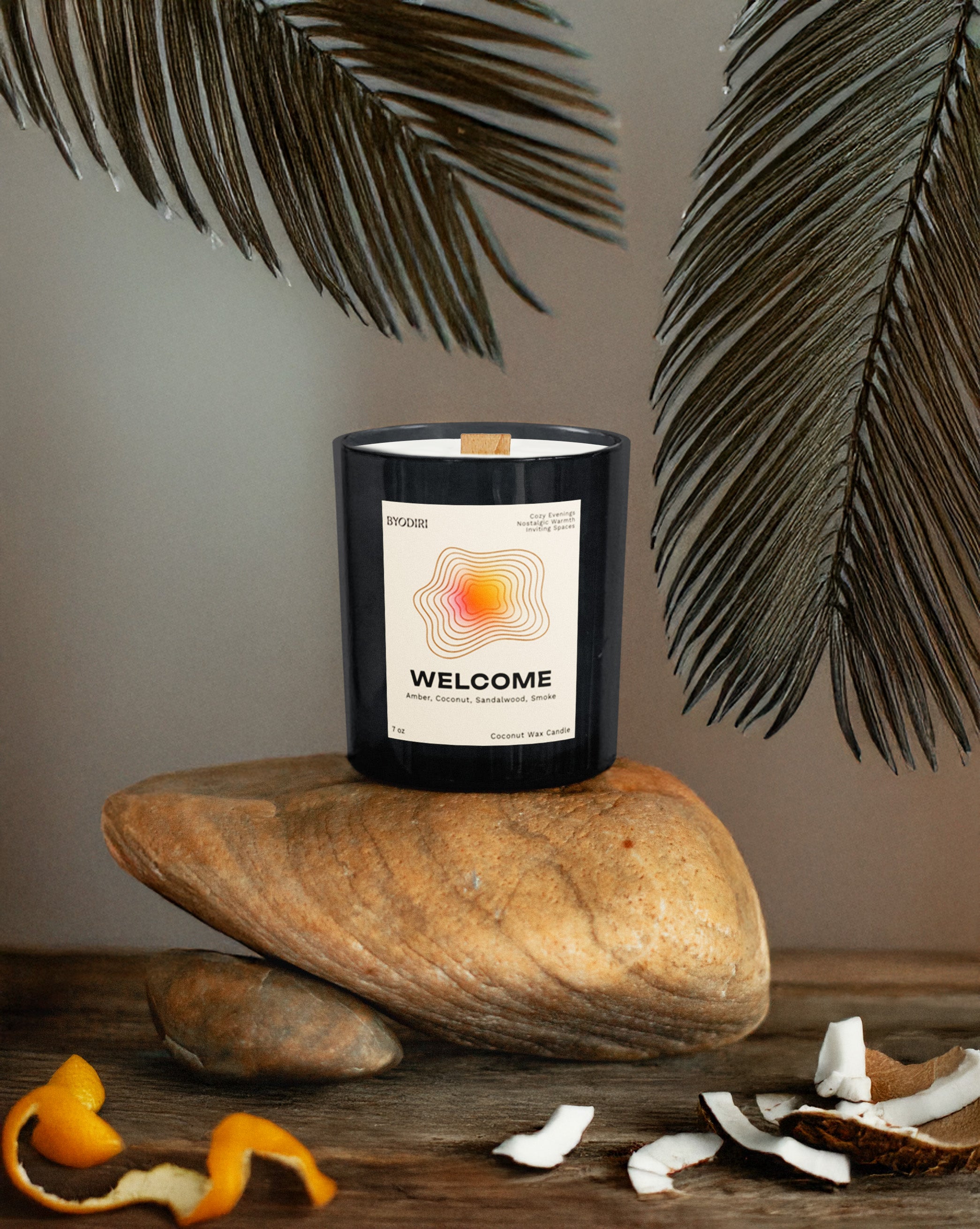 Candle labeled 'Welcome' on a stone surface with decorative elements