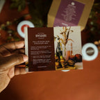 Hand holding a Byodiri Fall/Winter 2025 Discovery Box flyer with a blurred background