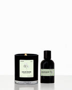 Candle and bottle with 'Calm House' label on a white background