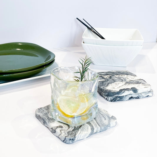 marble coaster on a tabke with green plates