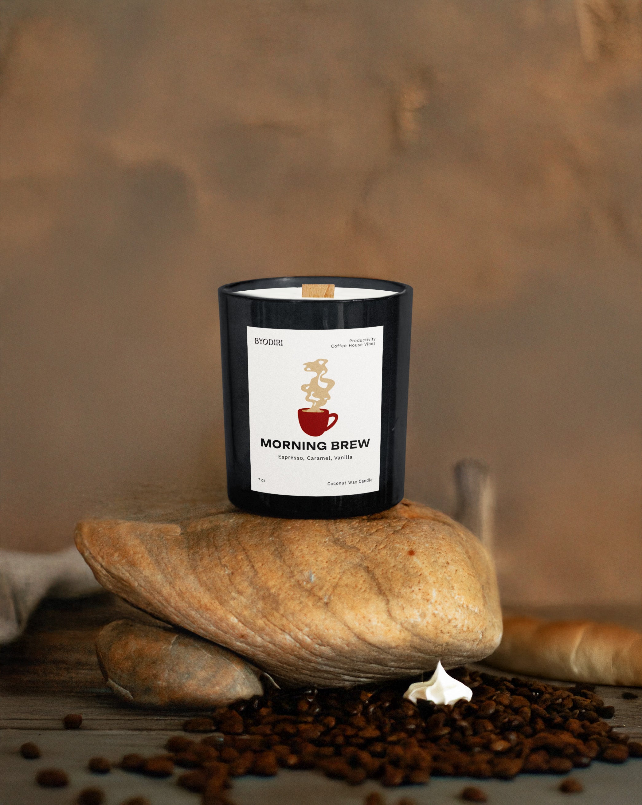 Candle labeled 'Morning Brew' on a stone with coffee beans and a piece of bread in the background.